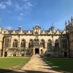 Historic Oxford University quad under blue sky