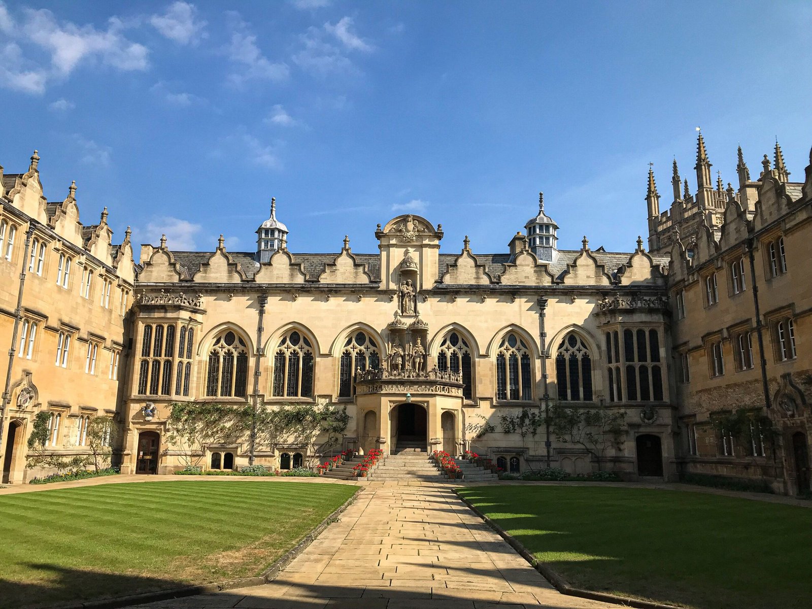 Historic Oxford University quad under blue sky